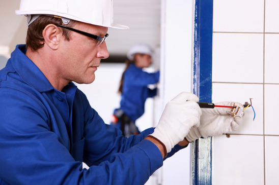 Electrician working on commercial washroom